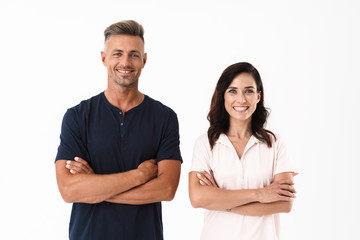 Cheerful couple wearing casual outfit standing isolated