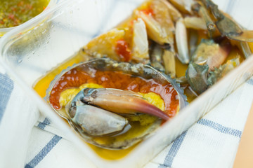 Pickled crab eggs in fish sauce pack in plastic box. Sea food industry..