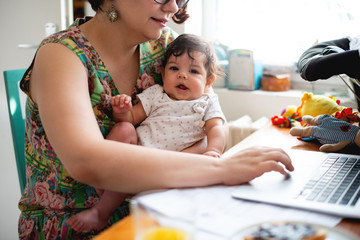 Smiling baby in mothers lap