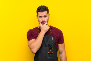 Barber man in an apron thinking an idea