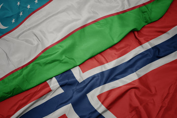 waving colorful flag of norway and national flag of uzbekistan.