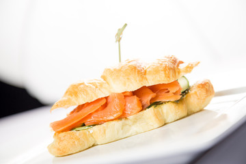 croissant with salmon on a white background