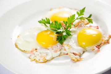 fried eggs and omelet with vegetables on a white background