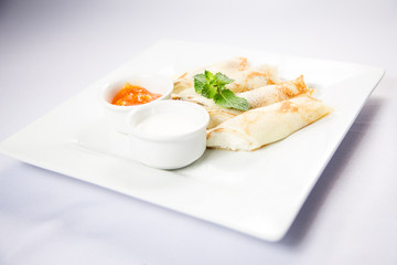 cottage cheese with sour cream and jam on a white background