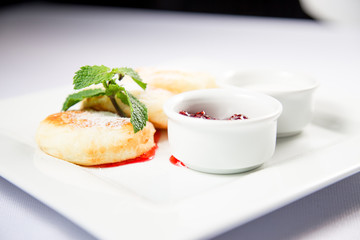 cottage cheese with sour cream and jam on a white background