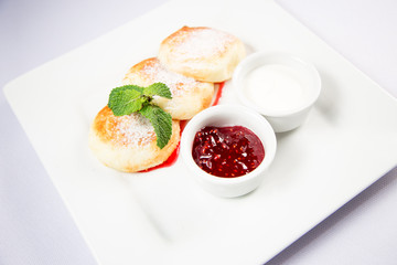 cottage cheese with sour cream and jam on a white background