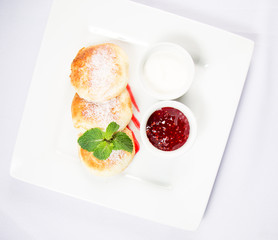 cottage cheese with sour cream and jam on a white background