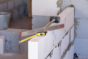 Work tools on a new wall. Building a home concept