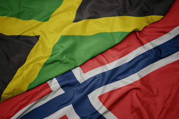 waving colorful flag of norway and national flag of jamaica.