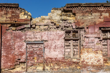 Old wall of destroyed house. Old powder wall with walled window and gates, doors. Ruined house. Remains of old houses. Apocalypse Abandoned city Broken building. Effects of earthquake, economic crisis