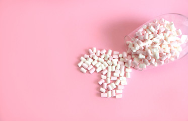 white and pink marshmallows in a glass cup. Heart made of marshmallows. Valentine's day concept