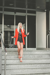 Elegant young woman walking down the stairs