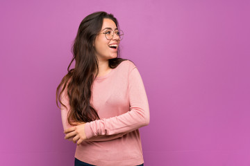 Fototapeta premium Teenager girl over purple wall happy and smiling