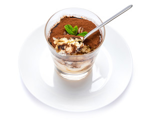 Classic tiramisu dessert in a glass cup on the plate on white background with clipping path