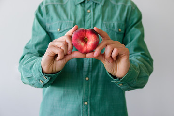 Man with heart shaped peach
