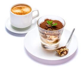 Classic tiramisu dessert in a glass cup, savoiardi cookies and coffee beans on white background with clipping path