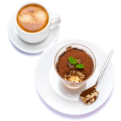 Classic tiramisu dessert in a glass cup, savoiardi cookies and coffee beans on white background with clipping path