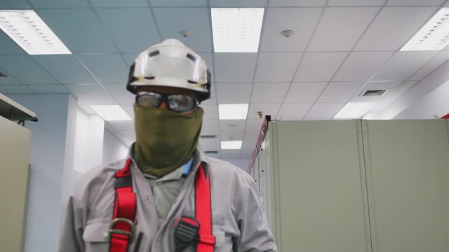 Electrical engineer working in electricity substation. Portrait style of engineer with personal protection uniform