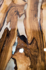 Texture of the table is made from solid wood treated with varnish and epoxy resin