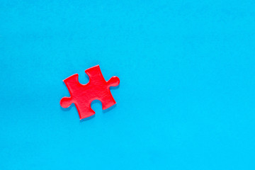 red puzzle piece over on blue background