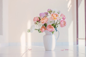 beautiful roses in ceramic white jug