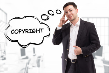 Business, technology, internet and network concept. The young businessman comes up with the keyword: Copyright