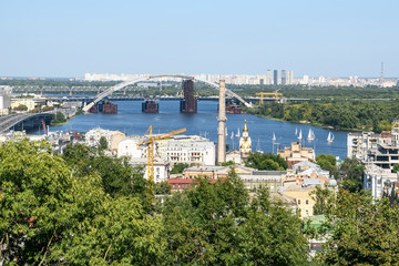 View of the old Podil district of the city of Kyiv and Dnipro River Dnieper with various bridges. Ukraine, August 2019