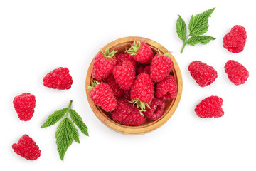 raspberries in wooden bowl with leaves isolated on white background. Top view. Flat lay