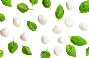 Creative layout with Mozzarella balls and  basil leaves isolated  on white background. Top view