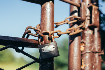 padlock locked on rustic door with chain outdoors