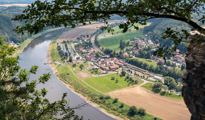 Fototapeta na wymiar Scenic view over the village Rathen and the Elbe River in the Saxon Switzerland.