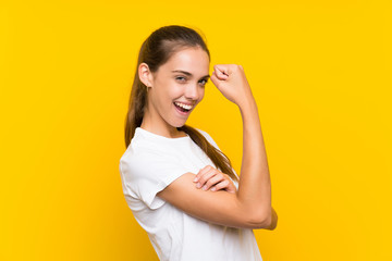 Young woman over isolated yellow background making strong gesture