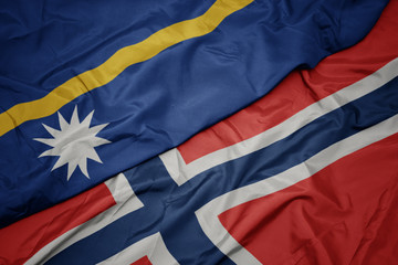 waving colorful flag of norway and national flag of Nauru ,.