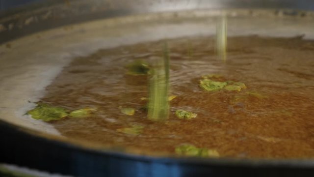 Adding fresh dried hops in boiling beer wort during a brewing process