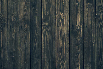 Vintage black vertical wood planks. Brown wooden grunge timber boards. Dark wooden panel texture. Dirty fence, carpentry hardwood. Natural material, rough surface of oak table. Vintage weathered floor