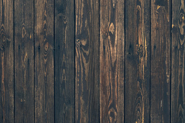 Fototapeta premium Dark wood vertical planks. Wooden rustic pattern of timber floor. Dirty wall, brown pine texture. Abstract natural background.