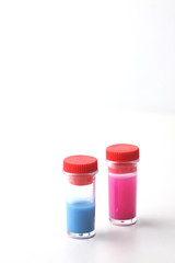 two test-tubes on white background. Image contains copy space