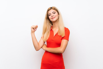 Teenager girl over isolated white background doing strong gesture