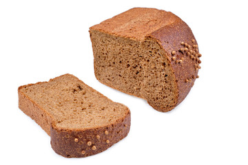 loaf of dark bread partly cut in slices, isolated on white