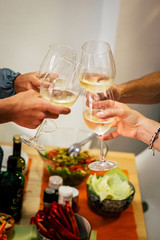 group of people, adults at night at home or restaurant celebrating smething, for example a birthday or anothr succes with a glass with vine