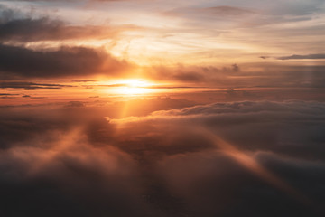 Fototapeta na wymiar Beautiful sunset sky with light rays view from airplane