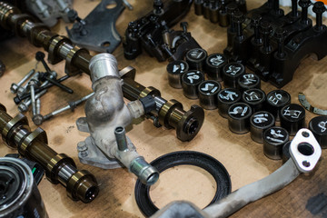 old disassembled engine parts, camshaft, engine chain bolts, hydraulic compensators, oil filter,...