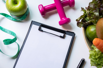 Clipboard with healthy fruit, vegetable and measuring tape on nutritionist desk, Right nutrition...