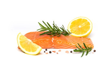 Fresh salmon steak with herbs and lemon isolated on white background