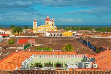 Foto op Aluminium Urban skyline of Granada city at sunset with its spanish colonial architecture, colorful cathedral and beautiful rooftops with the Nicaragua Lake in the background, Nicaragua, Central America. © SL-Photography