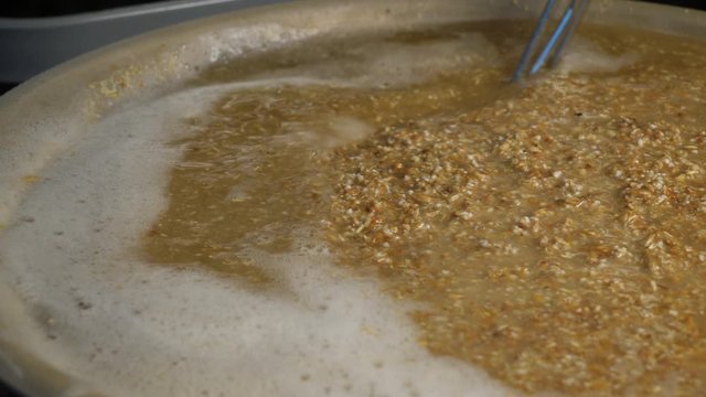 Brewing beer and Stirring malt mash in a home brewing process