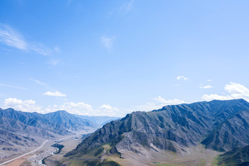 Aerial landscape with mountains and river under blue sky in summer