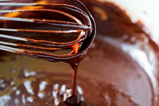 Close up of whisk mixing batter for chocolate brownies