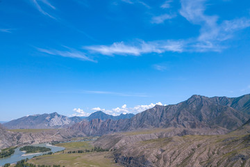 Aerial landscape with mountains and river under blue sky in summer