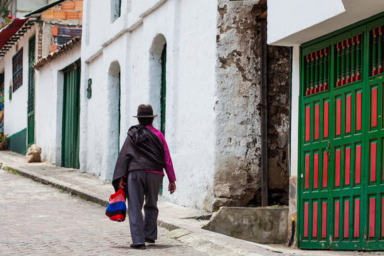 Woman dressed with traditional hat and ruana at the beautiful streets of the small town of Mongui in Colombia